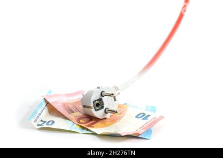 Electric schuko plug lying on euro banknotes, the cable is rising and turns to red, symbol of increasing energy costs, isolated on a white background, Stock Photo