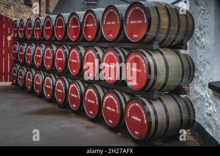 Bushmills, Northern Ireland, Aug 2019 Rows of large wooden barrels with maturing single melt Bushmills whiskey in Old Bushmills Distillery Stock Photo