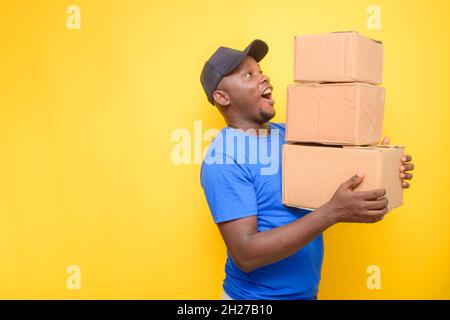 An African delivery or dispatch man carrying boxes Stock Photo