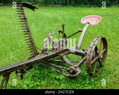 Old sickle bar mower on the grass Stock Photo