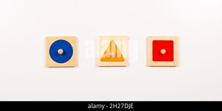 Colorful wooden Montessori sensorial material learning educational toys on white background. Geometric shape sorting board toys for baby kids. Top Stock Photo