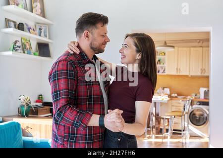 Happy romantic middle aged couple dancing at home Stock Photo