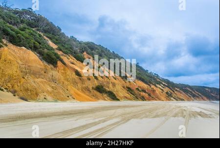 the coloured sand of the eroded sand dune cliffs of Rainbow Beach in the Cooloola Section of the Great Sandy National Park, Gympie Region, Qeensland, Stock Photo