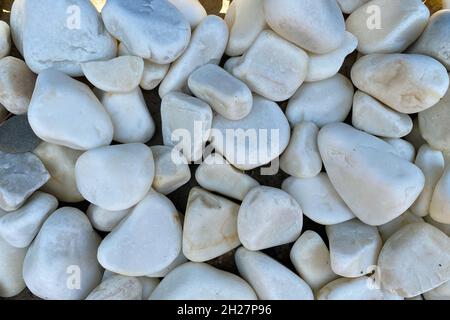 smooth round pebbles texture background, sea pebbles close-up, light grey stone Stock Photo