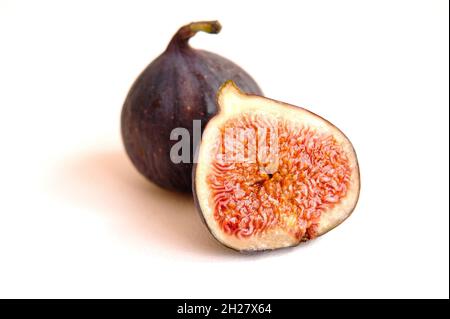 Fresh whole and bisected figs isolated on white background. Stock Photo