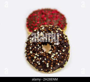 Donuts with chocolate topping isolated on a white background with copy space. Sweet food concept. Close up, selective focus Stock Photo
