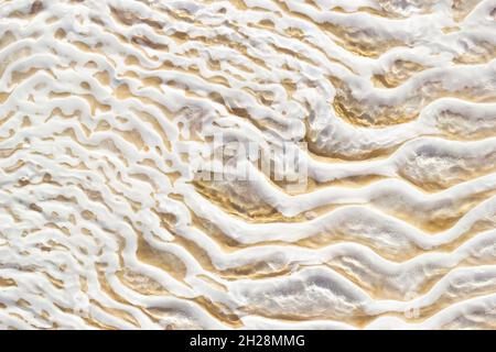 White-beige texture of Pamukkale calcium travertine in Turkey, uneven pattern, close-up Stock Photo