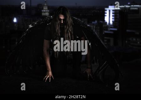 Man with black wings, fallen angel concept Stock Photo