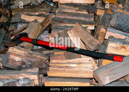 Big cleaver ax on a pile of firewood close-up. Stock Photo