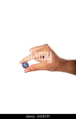 Hand holding blue clothes button. Isolated on white background. Stock Photo