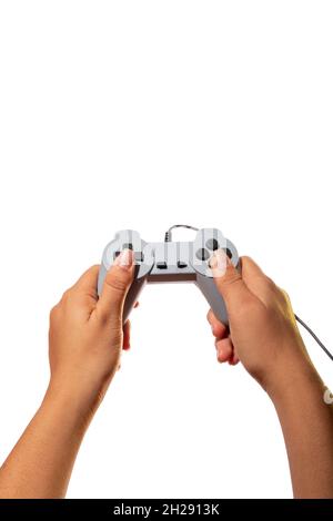 Hands playing with joystick control isolated on white background. Latin woman hands. Stock Photo