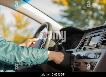 Closeup of a driver hand starting the car with the key Stock Photo