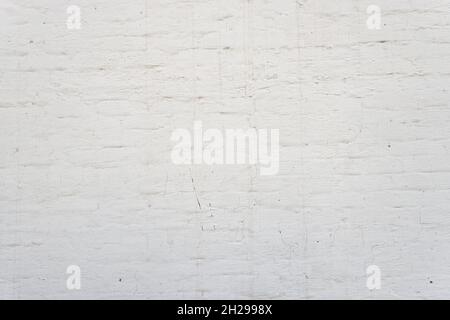 White brick wall background. Simple grungy white brick wall as seamless pattern texture background. Stock Photo