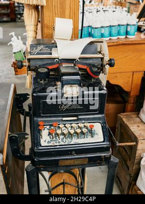 Antique Dalton Adding Listing and Calculating Machine, built in the early 1900's on static display in a farmer's market in Ellijay Georgia, USA. Stock Photo