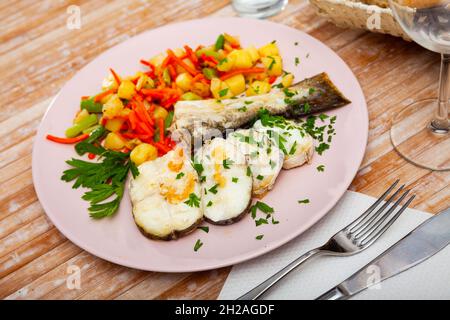 Oven baked hake with vegetable garnish Stock Photo