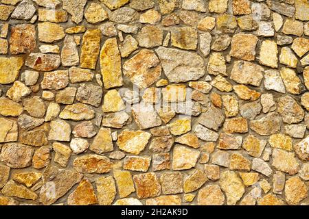 Background of dark yellow orange rough stone wall texture horizo Stock Photo