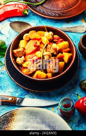 Meat ragout with mushrooms, zucchini, tomato and potatoes. Braised meat Stock Photo