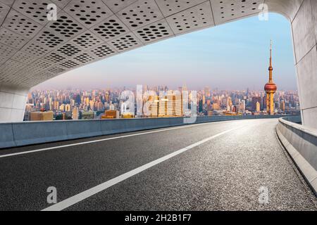 Asphalt road and city skyline at sunrise in Shanghai. Stock Photo