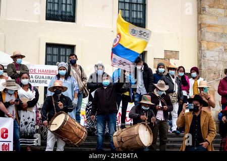 Bogota, Colombia, October 20, 2021. A demonstrator waves a flag during a protest against Colombia's government acts and laws in congress. In Bogota, Colombia on October 20, 2021. Stock Photo