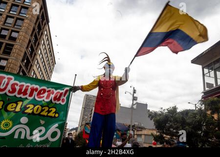 Bogota, Colombia, October 20, 2021. A demonstrator waves a Colombian flag during a protest against Colombia's government acts and laws in congress. In Bogota, Colombia on October 20, 2021. Stock Photo