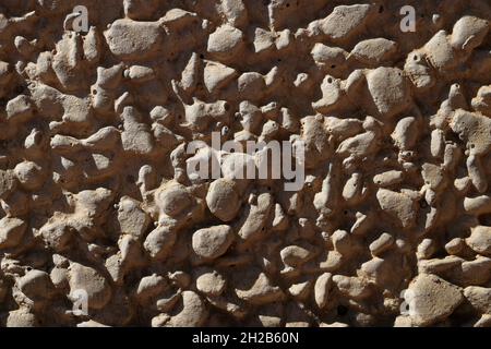 Background close up of an exposed aggregate concrete wall slab with pebbles. Background, abstract, construction concept. Stock Photo
