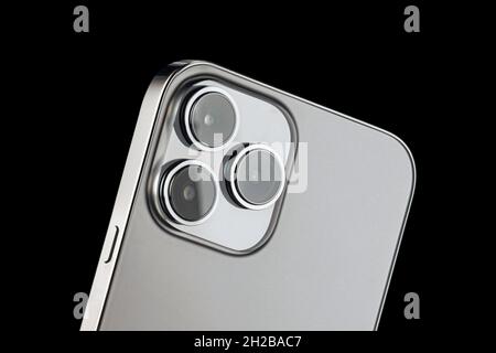 a modern phone with three cameras for photography and video shooting. close-up phone lenses from the back of the phone. Stock Photo