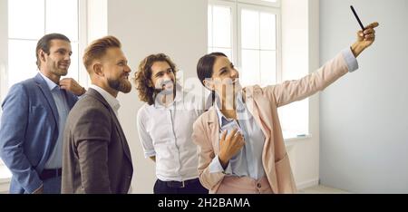 Smiling diverse employees make selfie on cellphone Stock Photo