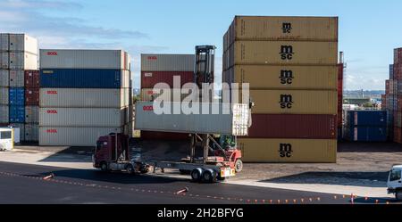 shipping container storage yard a forklift putting a container on a truck in sydney 05-16-2020 australia Stock Photo