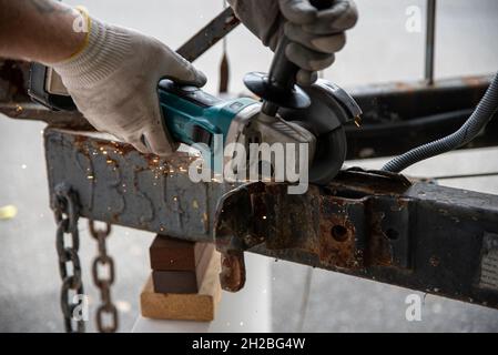 worker using a metal grinder machine Stock Photo
