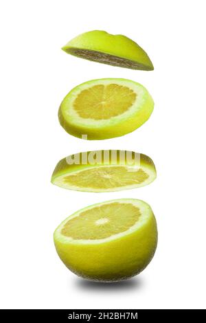 Sliced flying orange grapefruit isolated on white background. Cut orange grapefruit in pieces. Levity fruit floating in the air. Flying food concept. Stock Photo