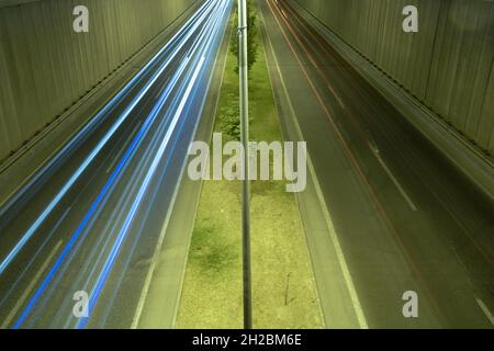 Light trails on the underpass road at night. Traffic or highway background photo. Stock Photo