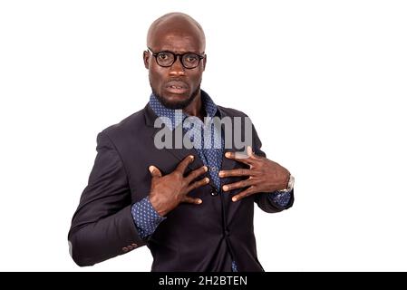 a handsome young businessman in suit standing on white background questioning you surprised. Stock Photo