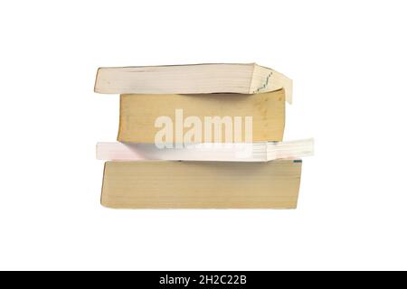 Closeup group of stacked thick books isolated on white background. Stock Photo