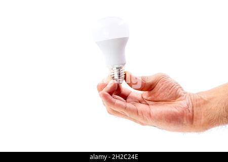 Human hand holding LED light bulb isolated on white background. Stock Photo