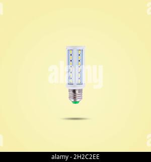 LED energy saving lamp 230v isolated on yellow pastel color background. Stock Photo