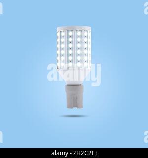 LED energy saving lamp 230v in a ceramic socket isolated on blue pastel color background. Stock Photo