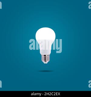 LED energy saving lamp 230v isolated on blue pastel color background. Stock Photo