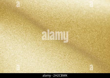 gold color glitter paper abstract, natural defocused texture, blurred shiny background, new year photography Stock Photo