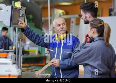 team of engineers having discussion in factory Stock Photo