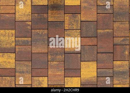 seamless texture and background of brown and yellow melange rectangular artificial stone pavement Stock Photo