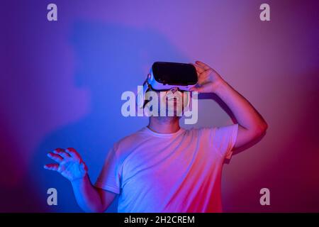 young man using virtual reality glasses is getting happy. Stock Photo