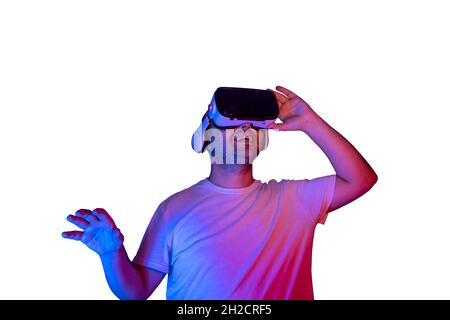 Young man using virtual reality glasses isolated getting happy. Stock Photo