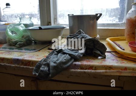 Kovrov, Russia. 1 December 2017. Glass jars with sauerkraut and salt, sunflower oil in plastic bottle, garlic in a bag and empty metal utensil on a wi Stock Photo