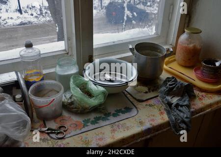 Kovrov, Russia. 1 December 2017. Glass jars with sauerkraut and salt, sunflower oil in plastic bottle, garlic in a bag, scissors, empty coffee can and Stock Photo