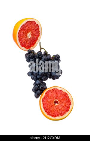 Dark blue grape with red grapefruit isolated on white background Stock Photo