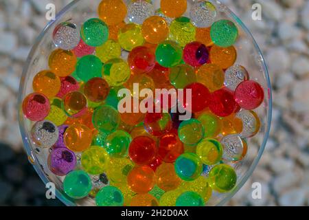 close-up of semitransparent colored balls in glass container. concept texture or background Stock Photo