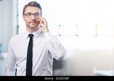 On the phone to another business lead Stock Photo