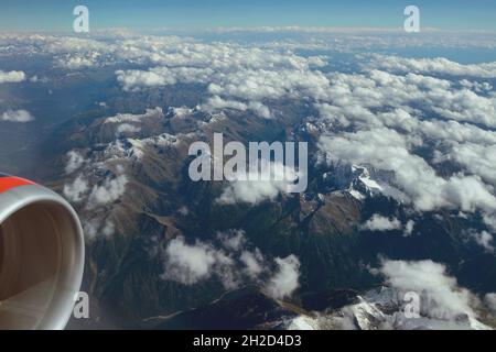 Plane view of mountains and clouds. Caucasus, Krasnodar Territory, Russia