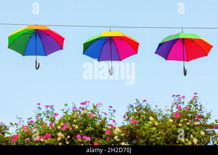 rainbow colored umbrellas on a line Stock Photo
