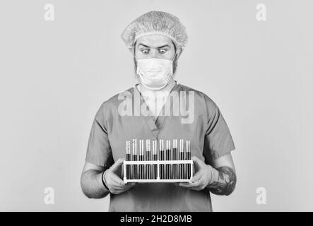 Genetic analysis. Critical number or density of susceptible hosts. Epidemic threshold. Man in medical lab inspecting samples biological material Stock Photo